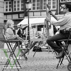 Street artist sketching a young boy, Strasbourg, France