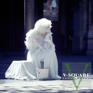 Resting street mime dressed as an angel, Barcelona, Spain